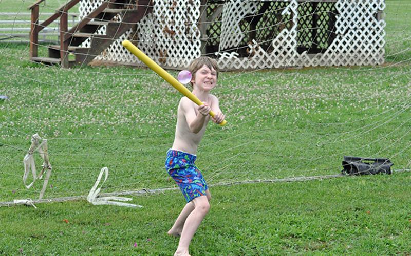 Wyatt Turpin crushes a water ballon during the Fannin Recreation Center’s summer camp, Wednesday, July 8.
