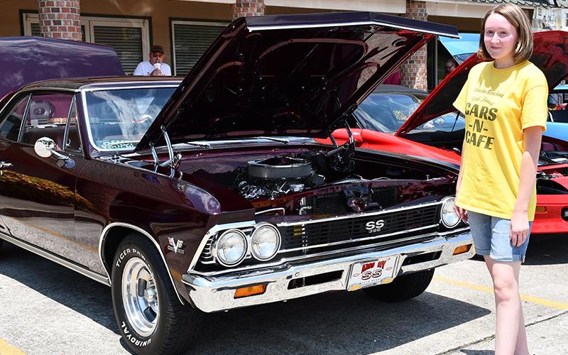 Shelby Pierce of Lovin Racing explored different cars at the Cars for a Cause car show fundraiser hosted by Lovin Racing and Circuit World to benefit Fannin County Family Connection Sunday, July 19.
