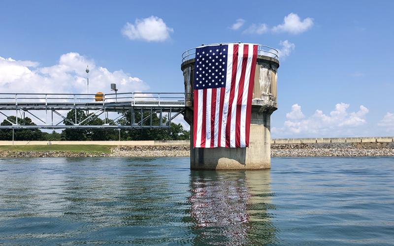 The Tennessee Valley Authority hung a huge American flag off the penstock at Blue Ridge Dam just in time for the Fourth of July. Tri-State EMC proudly displayed its flag from a boom truck at the office on Highway 5 south of McCaysville. Although crowds were smaller than some expected, thousands of people turned out for the annual fireworks displays in Blue Ridge and McCaysville/Copperhill.