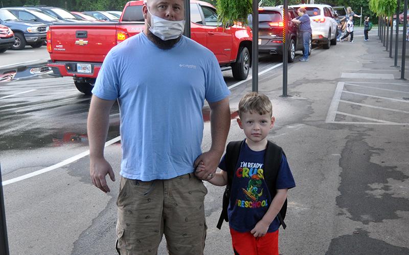 Mike Westphal walks his son, Gunner Westphal, to class on the first day of school for West Fannin Elementary School.
