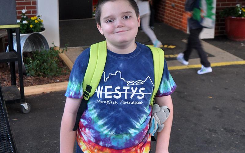 Fourth grader Patrick Thomas is all smiles as he walks to class during the first day of in-person school at West Fannin Elementary School since March.