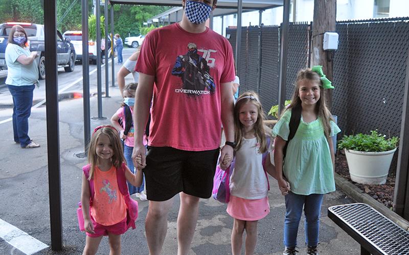 The Collins family traveled to West Fannin Elementary School for the first day of school Friday, August 7. Shown are, from left, Ryder, their father, Gavin, Lexa and Jadyn.