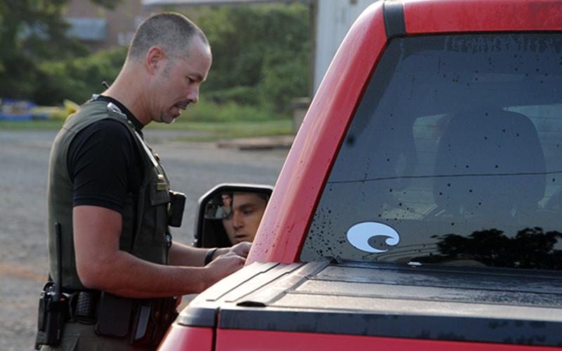 Fannin County Deputy Sheriff Lieutenant Darvin Couch warns a driver who was speeding through the school zone in front of Fannin County High School last week. Drivers will soon be issued citations for traveling faster than the 20 miles per hour lim