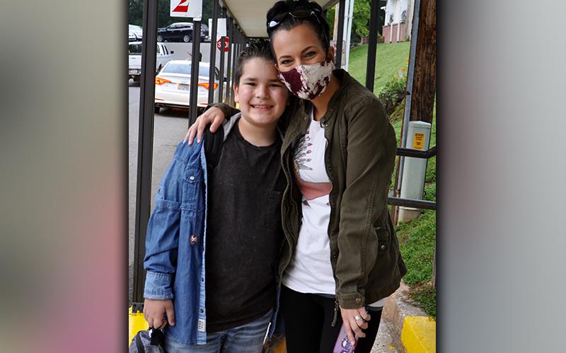 Carson and Nicole Towle wait outside Blue Ridge Elementary School, among many other families, on the first day of the 2020-21 school year Friday, August 7.