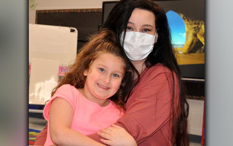 Blue Ridge Elementary School Kindergarten student Madelyn Davis holds onto her mom Jessica before the start of the school day.