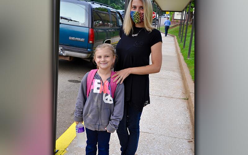 Kaylynne Chastain, right, and Lauren Tankersley pause for a photo before walking to class on the first day of school at Blue Ridge Elementary.