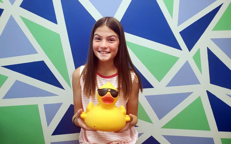 Boys &amp; Girls Clubs of North Georgia member Lauren holds up one of the ducks that will appear in this year’s duck drop fundraiser.