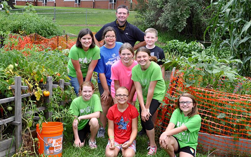 Copper Basin Elementary School’s Garden Club produces food for not only the young gardeners to take home, but also provides the community fresh produce. Gardeners are shown between some heirloom tomatoes and corn. Shown are, from left, front, Kendall Hughes, Madison Hester and Jalyn Hunt; middle, Raegan Farner, Gabby Lewis, Camryn Dockery and Emma Hester; back, advisor Gerome Smith and Silas Adams.