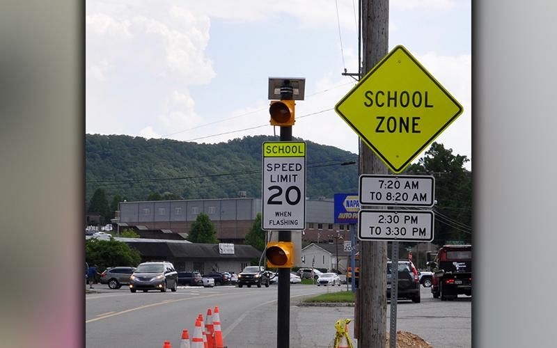 Flashing lights and signs give a clear warning of the school zone in front of Fannin County High School.