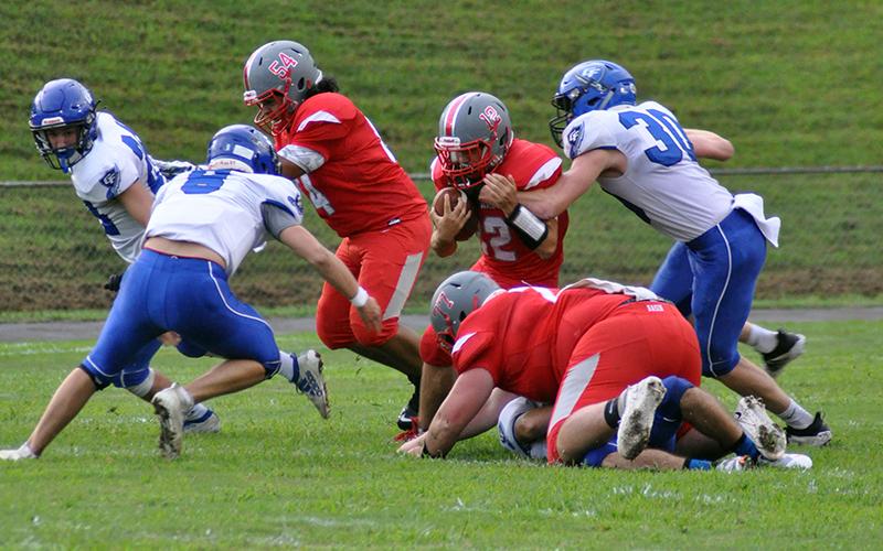Sebastian Balilies (12) fights through defenders as Krus Sotos (54) and Chance Rollins (77) block  during the Cougars 14-12 win over Georgia Force Friday, August 28.