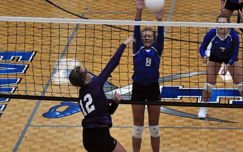 Reagan York attempts to block a spiked ball in recent action for the Lady Rebels volleyball team.