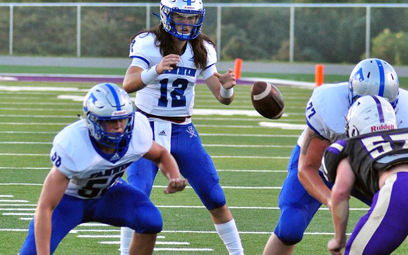 Rebel quarterback Luke Holloway snaps the ball in recent action for the Fannin County Rebel football team.