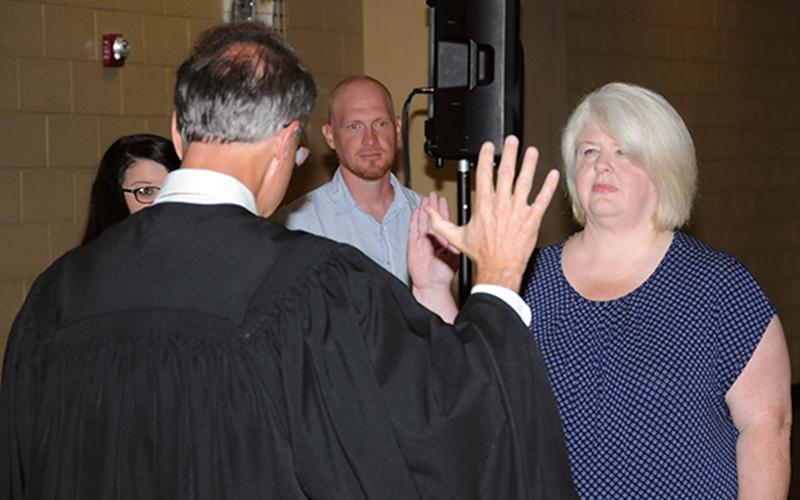 New Third District school board member Jill Crago Rose took her oath of office from Circuit Court Judge Mike Sharp.