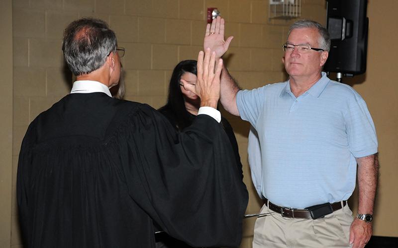 Robert “Robbie” Cole, who was re-elected to the school board from the Third District, took his oath of office from Circuit Court Judge Mike Sharp.