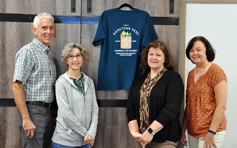 Fannin County Family Connection volunteers were treated to a large lunch and were gifted T-shirts Friday, September 25. Shown next to a shirt is, from left, Tom and Nancy Niswander, Priscilla McDonald and Kathy Jones.