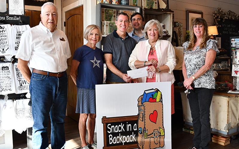 Blue Ridge Cotton Company and Gather raised $5,005.44 for Snack in a Backpack through their 1% charity program in honor of their son, Michael. Shown are, from left, Snack in a Backpack board members Jeff O’Neill and Toots Greene, Owners Gary Steverson and Joshua Durst, Executive Director Debby Beck and board member Jeanie May.