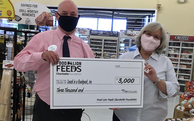 Blue Ridge Food Lion Store Manager Jeff Jones recently presented Snack in a Backpack Executive Director Debby Beck with a check for $3,000 on behalf of the Food Lion Feeds Charitable Foundation to go toward feeding the children of Fannin County.