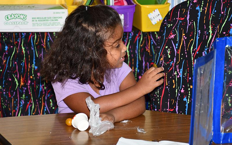 West Fannin Elementary School student Kinsley Grant discussed the heirloom tomatoes with her friends as they each tried the fruit.