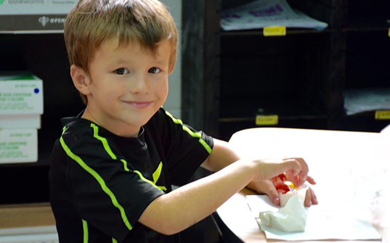 West Fannin Elementary School student Landon Dyer was excited to try the heirloom tomatoes provided to him as a school snack by the school’s Nutrition Department.