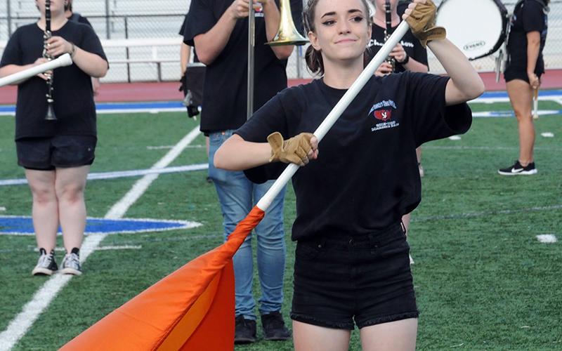Fannin County High School Marching Band colorguard member Shayna Bolmon tightly grips her flag pole while performing to the crowd at the Friday, August 28, halftime show.