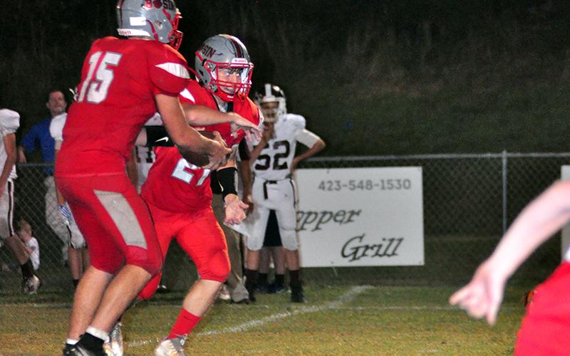 Copper Basin Cougar Joe Boggs (15) hands the ball off to Johnathan Johnson (21) in recent action for the Copper Basin Cougar football team.