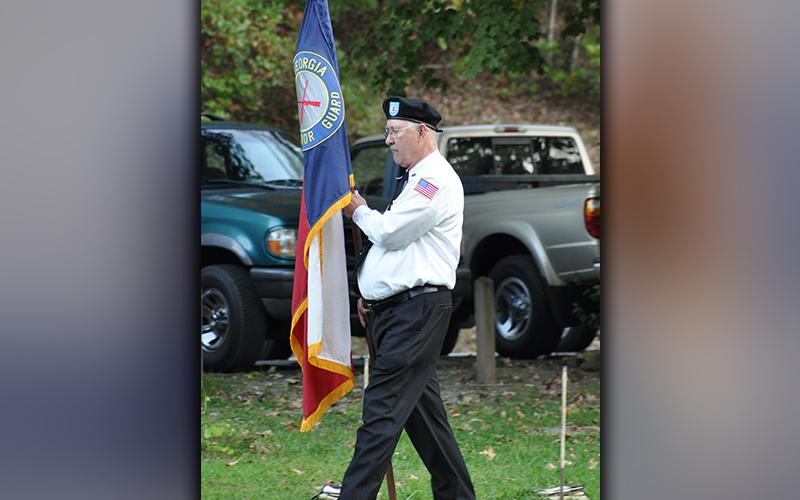Veteran Bob Harrington posts the North Georgia Honor Guard flag at Ron Henry Horseshoe Bend Park Tuesday, October 20. Besides the ceremonial posting of the colors, the Flag Retirement ceremony included an explanation of the importance of properly retiring worn out United States flags by Epworth Scoutmaster David Lewis. Troop 32 scouts and honor guard members come together regularly to conduct retirement ceremonies.