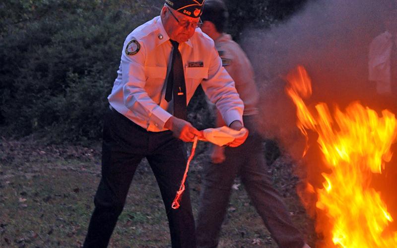 Veteran Richard Crosley retires a flag during a retirement ceremony held at Horseshoe Bend Park Tuesday, October 20.