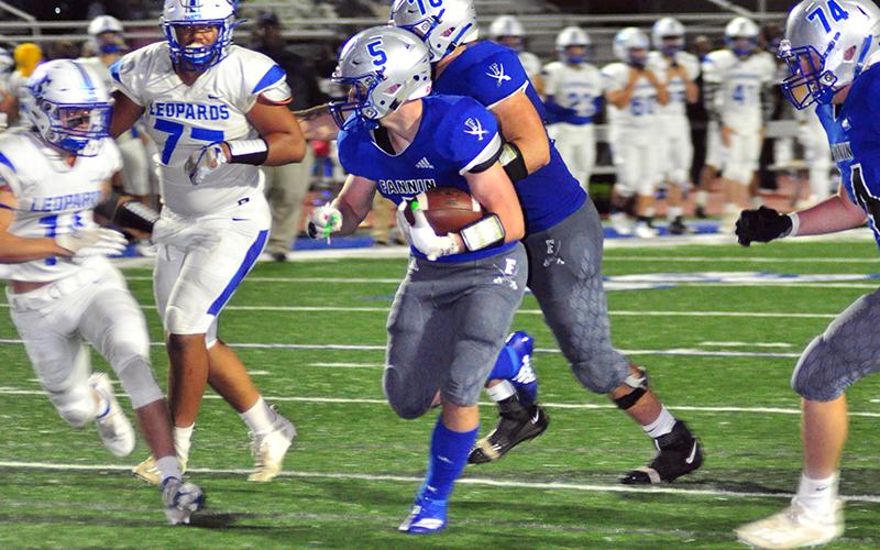 Fannin Rebel Seth Reece (5) takes the ball to the endzone, while Mason Bundy (70)  blocks a trailing defender during the Rebels 49-13 win over Banks Friday, October 2.