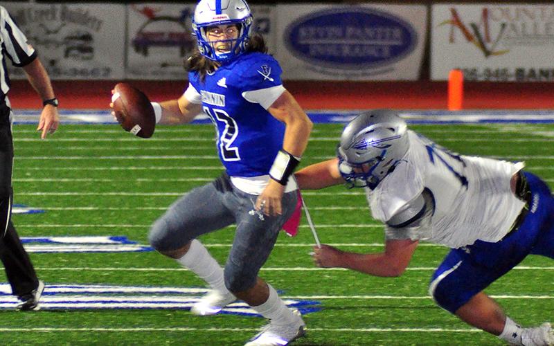 Rebel quarterback Luke Holloway scrambles out and avoids a defender during Fannin County’s game against the Gordon Central Warriors Friday, October 9.