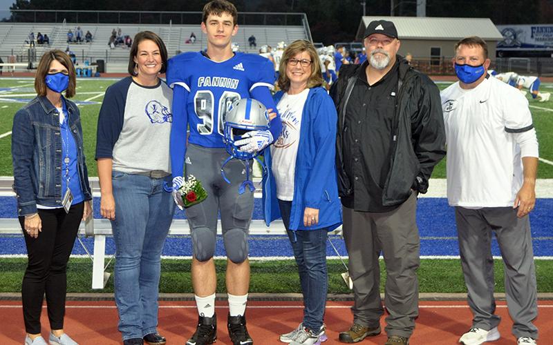 Fannin County senior Tommy Ledford was recognized with 15 other football seniors during the Rebels senior night ceremony Friday, October 9. Shown are, from left, Bridgette Butynski, Ledford, mother, Trish Ledford and father, Keith Ledford.
