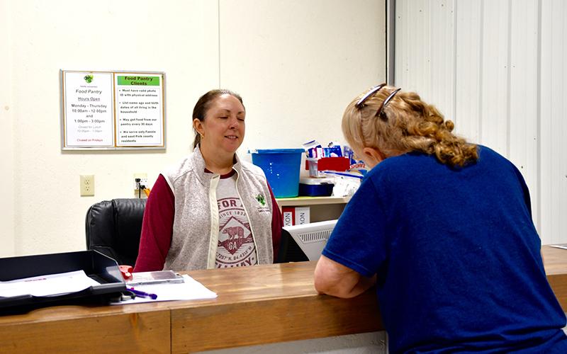 Mandy Hyde of Fannin County Family Connection takes an application from a client needing to receive funds from the TVA’s Community Care Fund Program.