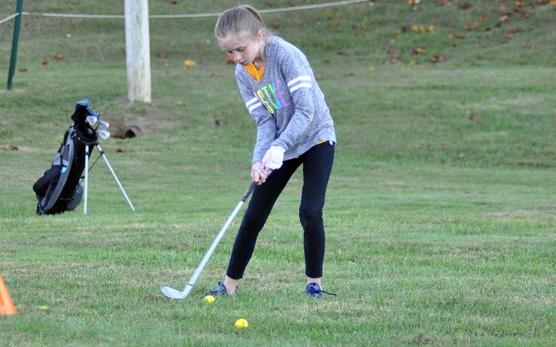 Eisley Barber works on hitting with her irons during the Recreation Department golf practice Tuesday, October 13.