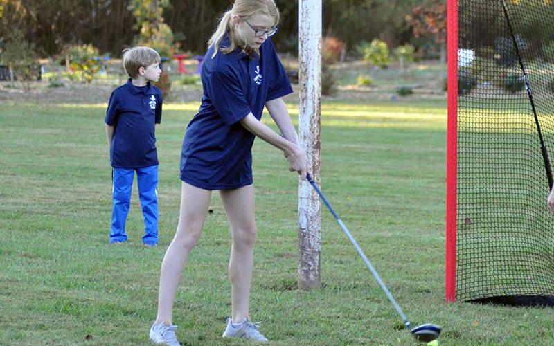 Arianna Galloway works on using her driver during the Fannin County Recreation Department golf practice Tuesday, October 13.