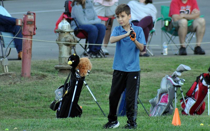 Colin Daughtery watches the golf ball travel during the Fannin County Recreation Department’s golf practice Tuesday, October 13.