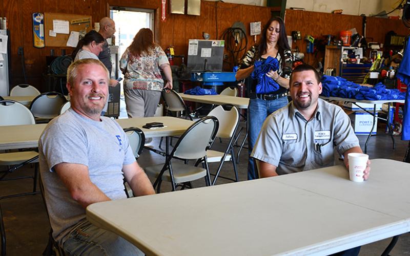 Fannin County School System bus drivers Brandon Tipton, left, and Anthony Rymer enjoy fellowship as they and their fellow bus drivers are honored during a School Bus Safety Week luncheon Thursday, October 22.