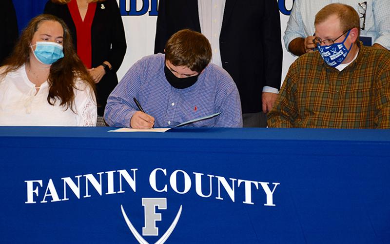 Fannin County Middle School student Wyatt Payne was one of five students to become Realizing Educational Achievement Can Happen (REACH) scholars during the annual REACH Signing Ceremony Wednesday, October 21. He is shown with his parents Kim and Jodi Payne.