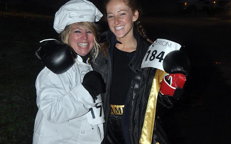 Barbara Galinski, left, and Jaque Galinski are all smiles as they wait to start the Bigfoot Boogie 5K race Saturday, October 31.