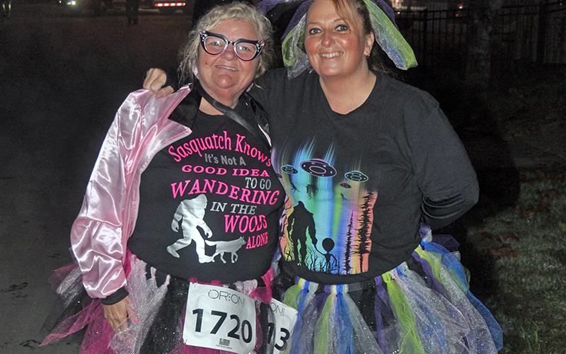 Teresa Hopkins, left, and Tracey Barcenas show off their costumes before the Bigfoot Boogie 5K Saturday, October 31.