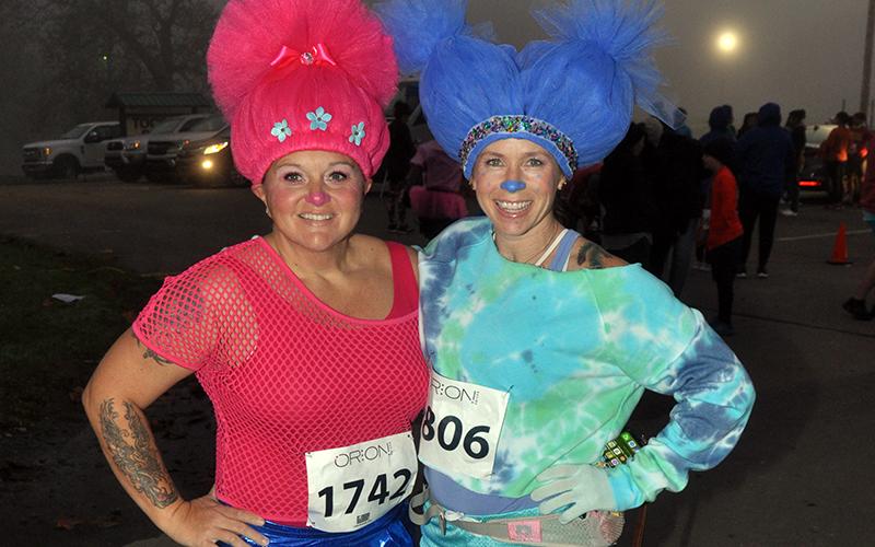 Amanda Ash, left, and Chris Disser prepare to run in their costumes at the Bigfoot Boogie 5K race Saturday, October 31.
