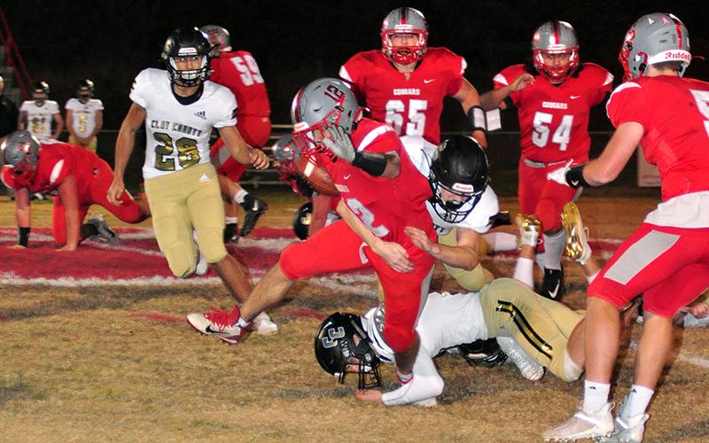 Sebastian Balilies (12) sheds a tackle during the Cougars game against the Clay County Bulldogs Friday, November 6.