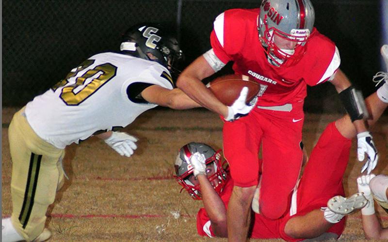 Dawson Worthy (7) fights for first-down yardage during the Cougars playoff game against the Clay County Bulldogs Friday, November 6.