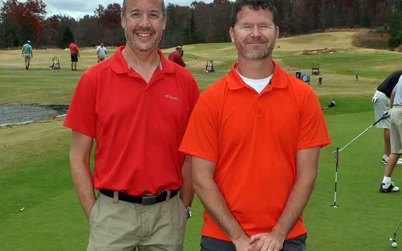 Golfers Nate Daugherty, left, and Chris Lawson warm up on the putting green before competing in the Blue Ridge Classic Scramble Tuesday, November 10.