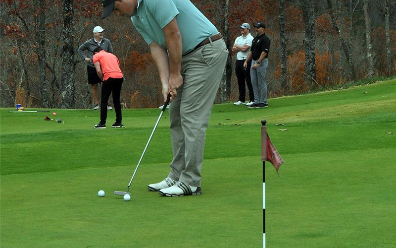 Matthew Yonz practices his putting just before tee time at the Blue Ridge Classic Scramble Tuesday, November 10. The tournament was a benefit for Blue Ridge Police Chief Johnny Scearce.