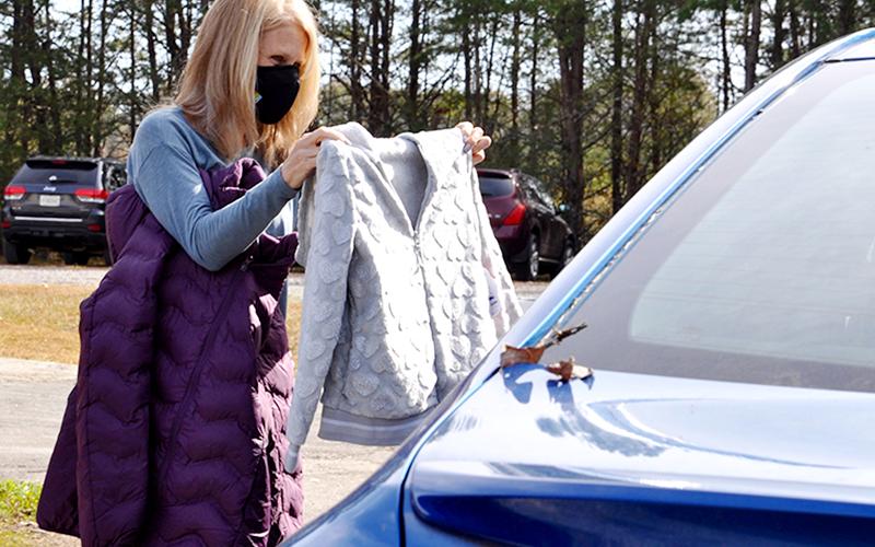 Allyson Brantley, Fannin County Family Connection volunteer, holds up a coat that was donated through The News Observer’s annual Coats for Kids coat drive for a parent to determine whether or not it will fit her little one Thursday, November 5. The coats were distributed at Family Connection where employees and volunteers helped complete the successful coat drive.