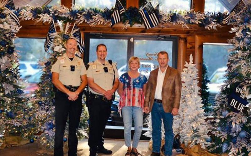 Folks have a chance to help local children through Fannin County’s Shop with a Cop program as Serenity in the Mountains has partnered with the program to host a Christmas Tour of Trees to raise funds. Shown are, from left, School Resource Officer (SRO), program organizer Lieutenant Darvin Couch, SRO Sergeant Jim Burrell, Serenity owner Lynda Cole and Sheriff Dane Kirby.