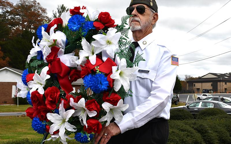 North Georgia Honor Guard member Nick Wimberley carries in a wreath in honor of the veteran lives lost during Fannin County’s Veterans Day ceremony Saturday, November 7.