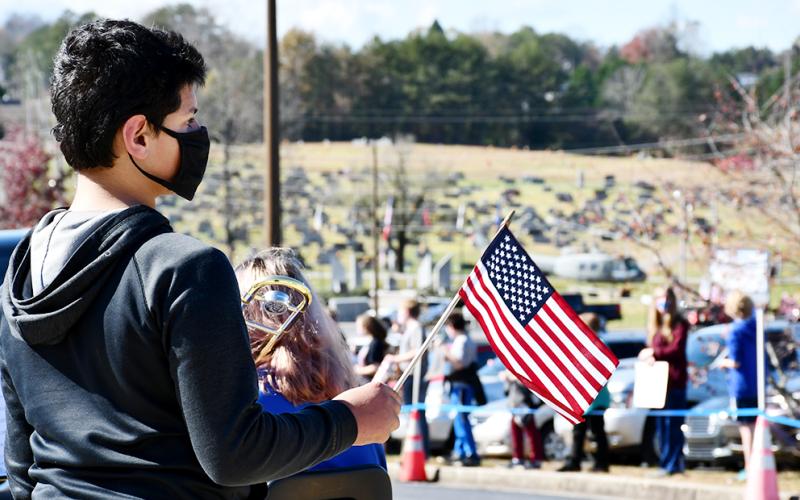 Fannin County Middle School student TJ Dunn waved the American Flag as area veterans drove by during the school’s drive-thru Veterans’ Day Parade Friday, November 6.