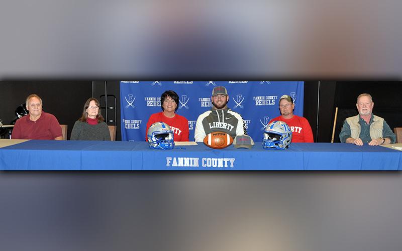 Fannin County football senior Mason Bundy signed to play football with the Liberty University Flames Wednesday, December 16. Shown following the signing are, from left, Jerry Garren, uncle; Cindy Garren, aunt; Dena Johnson, mother; Bundy; Chris Johnson, father; and Scott Johnson, uncle.