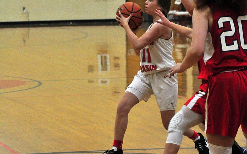 Lady Cougar Summer Montgomery passes to the open player during the Lady Cougars game against Polk County Thursday, December 3.