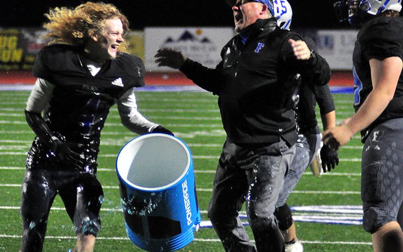 Cohutta Hyde (4) helps give Fannin Rebel Head Coach Chad Cheatham a Gatorade bath after the Rebels 28-21 win over Pace Academy Saturday, November 28.